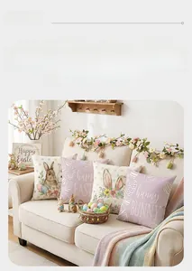 Detailed view of four Easter pillow covers with rabbit and egg prints on a sofa