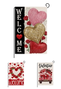 Detail of Valentine's Day garden flags featuring red roses and heart patterns on white fabric