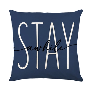 Blue linen cushion cover featuring white STAY awhile text in a square minimalist design