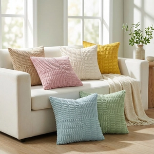 Set of six corduroy cushion covers with cross-stripe texture on a white sofa and floor
