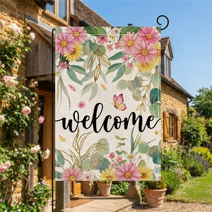 Floral burlap garden flag with welcome text and metal stand in a blooming summer garden
