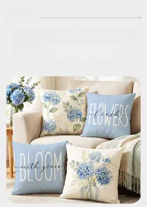 Detailed texture of blue hydrangea and floral typography on linen cushion covers