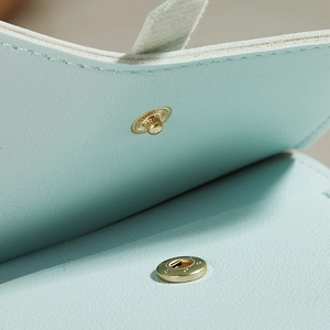 Vertical light blue leather crossbody phone bag with premium gold metal buckle detail