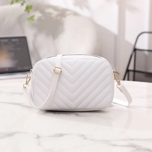 White faux leather crossbody bag with V-shaped quilting and gold metal hardware