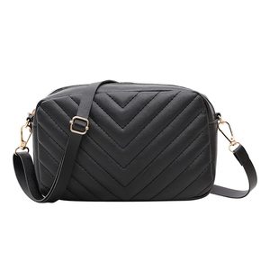 Classic black crossbody bag featuring V-shaped quilted stitching and gold hardware
