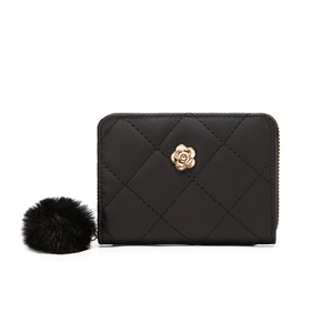 Black quilted small wallet for women with golden flower accent and pompom keychain charm