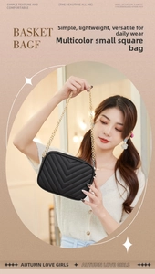 Detail of black V-quilted camera bag with gold chain strap held by a model