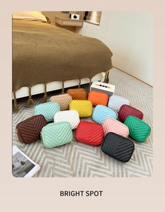 Detailed display of 14 colorful V-quilted faux leather crossbody bags with chain straps
