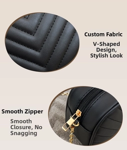 Detail of black V-quilted faux leather bag featuring smooth gold zipper and chain strap