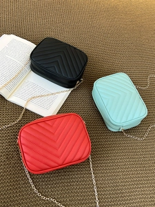 Quilted V-stitch crossbody bags in black, mint, and red with gold chain straps
