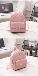 Detail view of pink quilted mini backpack with rose emblem and textured PU leather