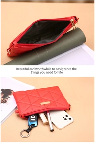 Detail of red quilted faux leather bag with gold zipper showing internal storage capacity