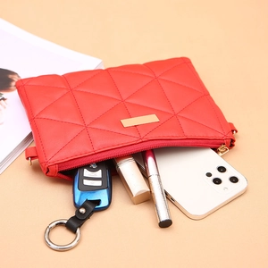 Red quilted crossbody bag for women showing interior space for keys, lipstick and phone