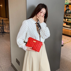 Elegant red quilted shoulder bag for women with a gold chain strap in a stylish square shape