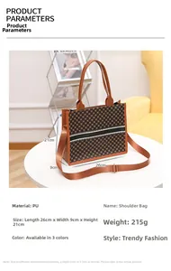 Close-up of brown geometric print PU tote bag showing dimensions 26x9x21cm and fabric strap