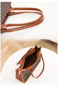 Detail of reinforced handles and secure golden metal zipper on monogram tote bag