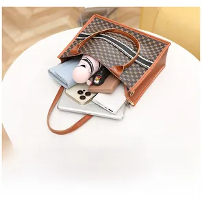 Open view of a large printed tote bag filled with tablet, umbrella, and accessories