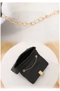 Detail of detachable gold chain strap and inner structure of black quilted crossbody bag