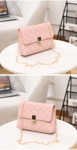 Detailed close-up of pink quilted faux leather shoulder bag with gold chain and twist lock