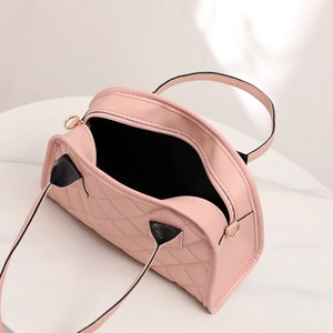 Pink quilted shoulder bag detail showing interior lining and gold zipper hardware