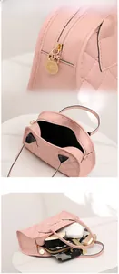 Pink quilted shoulder bag with black trim, golden hardware, and smooth zipper detail