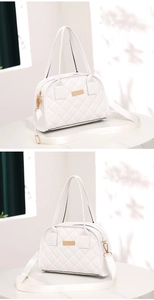 Detailed shot of white quilted crossbody bag with gold hardware and adjustable strap