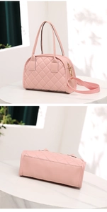 Detailed view of pink quilted handbag showing diamond pattern and wide shoulder strap