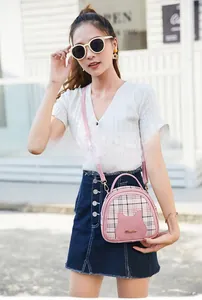 Pink checkered crossbody bag with cute cat ear design and adjustable leather shoulder strap