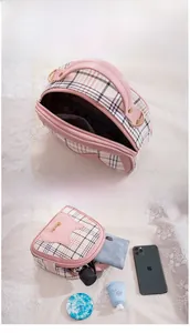 Spacious pink plaid bag showing storage for phone, wallet, umbrella and cosmetics