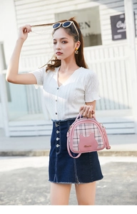 Detail of pink plaid mini bag with cat leather patch and adjustable shoulder strap