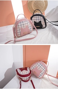 Detail of plaid cat-themed crossbody bags with PU leather finish and gold metal accents