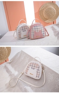 Detail of plaid shell bags with cute cat ear pockets in pink and white colors