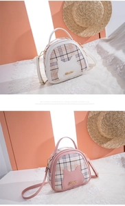 Detail of cute cat ear plaid handbag with metal logo and adjustable shoulder strap