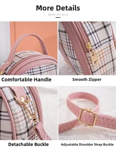 Detail view of pink plaid shell bag featuring top handle, smooth zipper and metal buckle