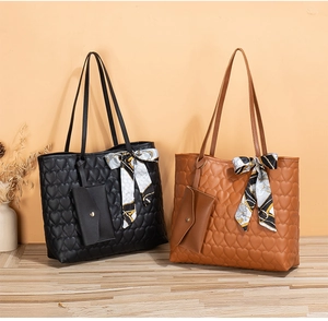 Quilted heart tote bag set with matching pouch and decorative silk scarf on display