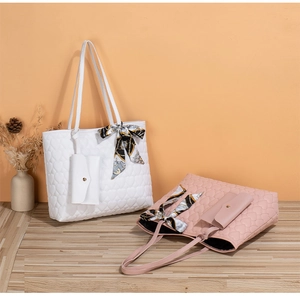 Detail of heart-quilted tote bags with printed silk scarves and matching mini pouches