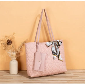 Pink quilted heart tote bag detail with silk scarf and matching coin purse on wood