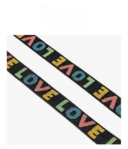 Close-up of durable double-stitched strap with colorful LOVE embroidery and high load capacity