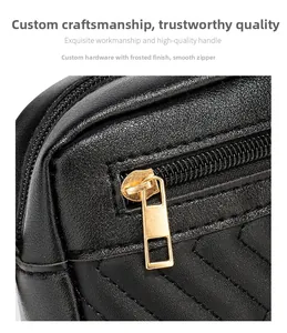 Detail of smooth metal zipper and frosted hardware on black wave-stitched camera bag