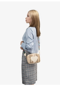 Close-up of straw crossbody bag with heart patch and colorful LOVE woven strap