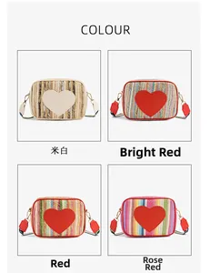 Detail view of woven straw crossbody bags in four colors with large leather heart patches