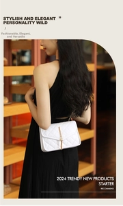 Detail of white quilted crossbody bag with golden tassel and metal chain strap