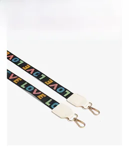 Detail of colorful LOVE letter embroidery on wide shoulder strap with gold metal hooks