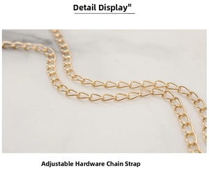 Close-up of golden metal chain strap with adjustable links for quilted crossbody bag