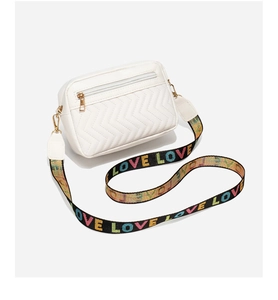 Close-up of white crossbody bag back with V-quilt pattern and colorful LOVE strap