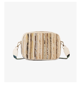 Detail of woven crossbody camera bag with striped patterns and colorful geometric strap
