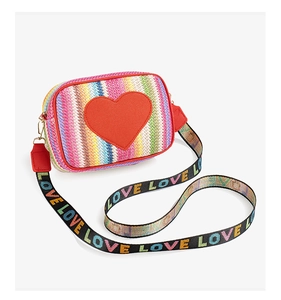 Detail of colorful woven straw bag featuring a red heart patch and printed LOVE wide strap