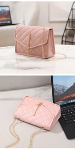 Detailed view of pink quilted shoulder bag featuring gold tassels and a chain strap
