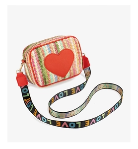 Detail of colorful woven crossbody bag with red heart patch and LOVE wide shoulder strap