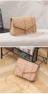 Macro detail of beige quilted crossbody bag featuring a gold tassel and metal chain strap